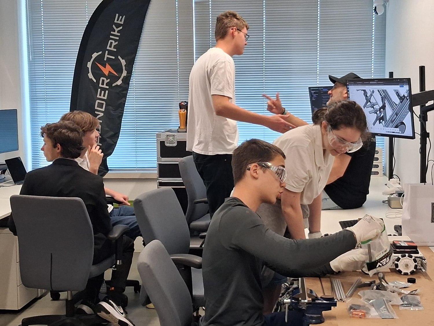 Visiting students working at the Thunderstrike bench with CAD open on the monitor behind them