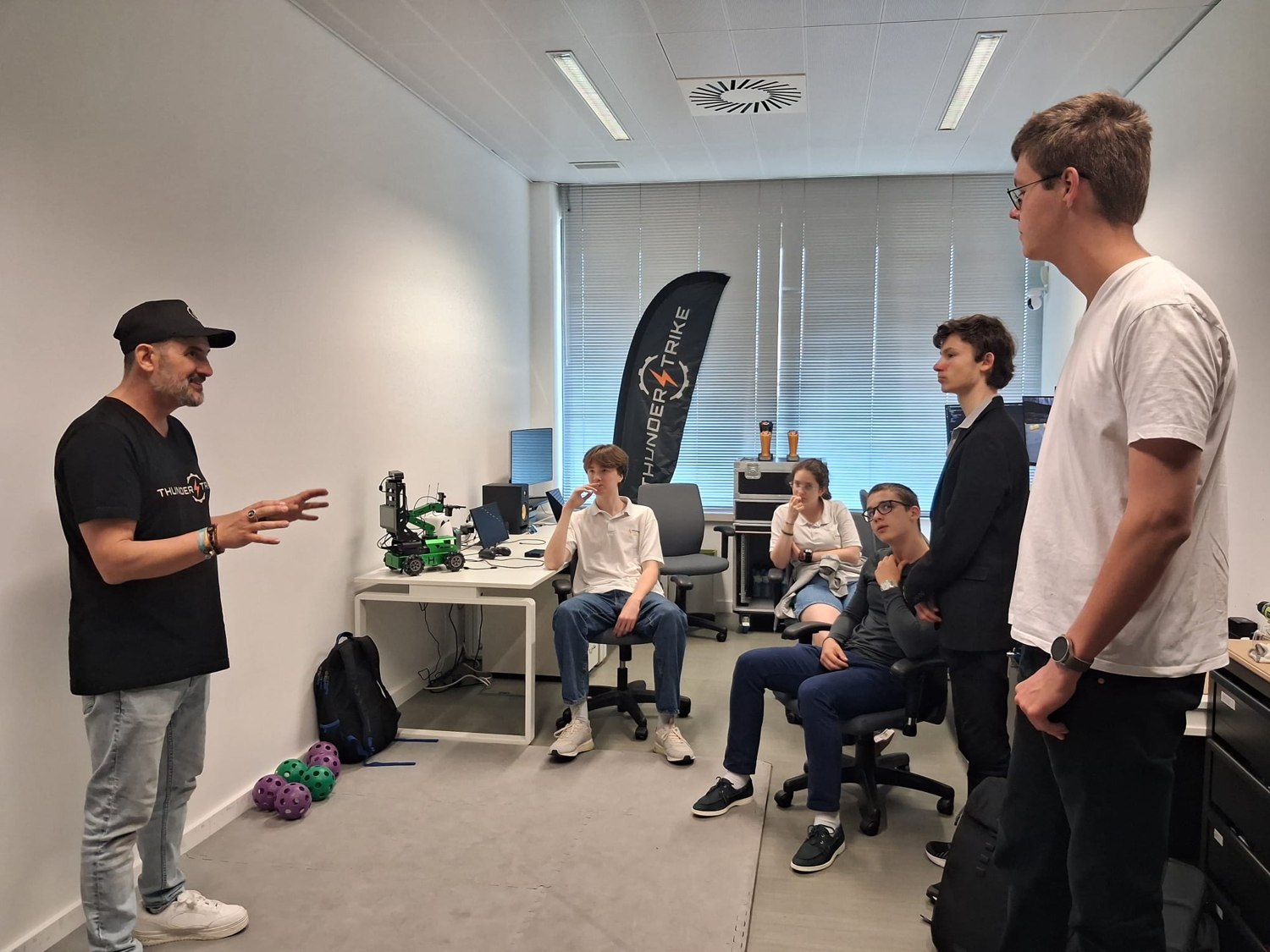 A mentor briefing a visiting school group