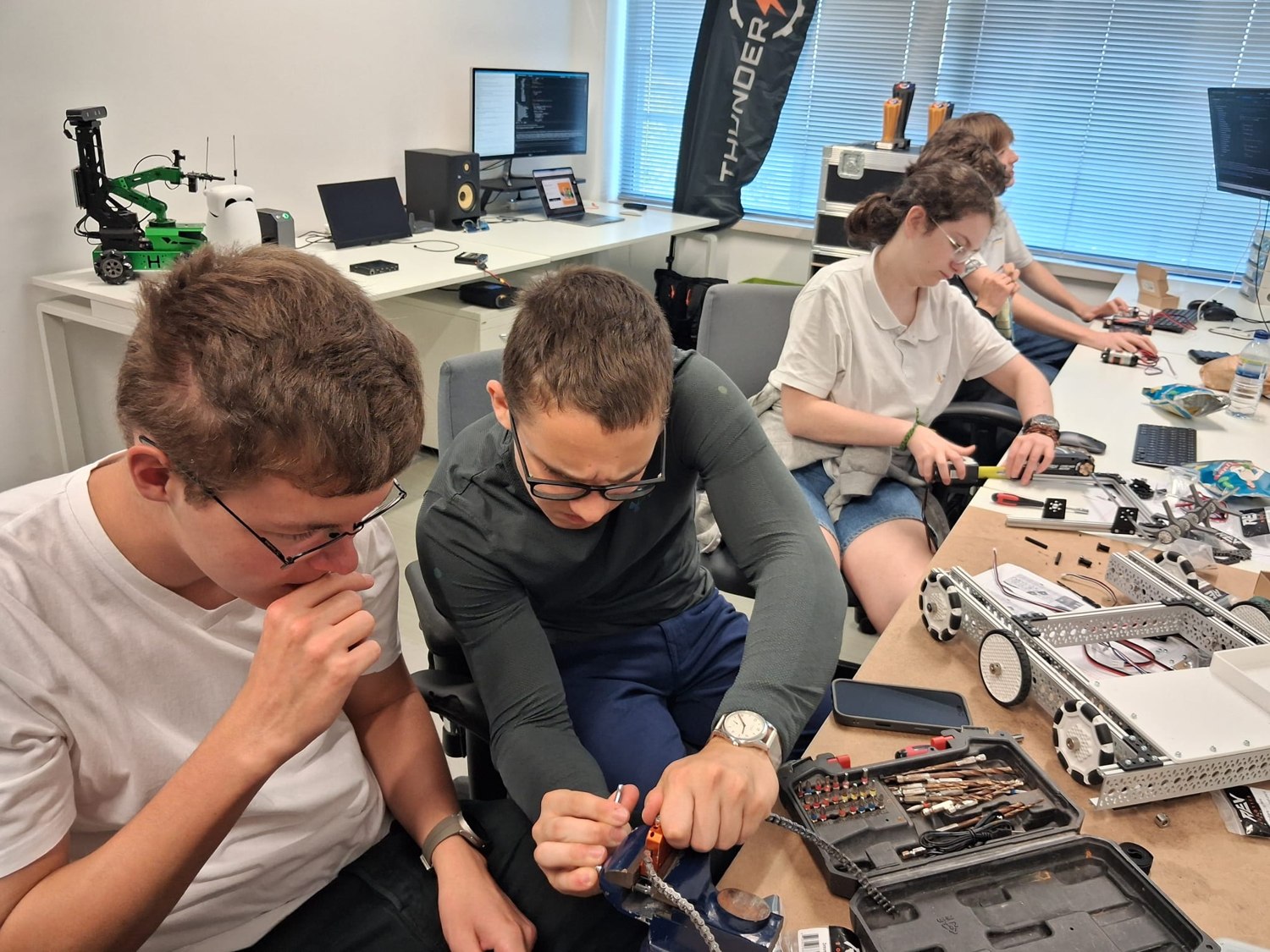 School students building a robot in the lab
